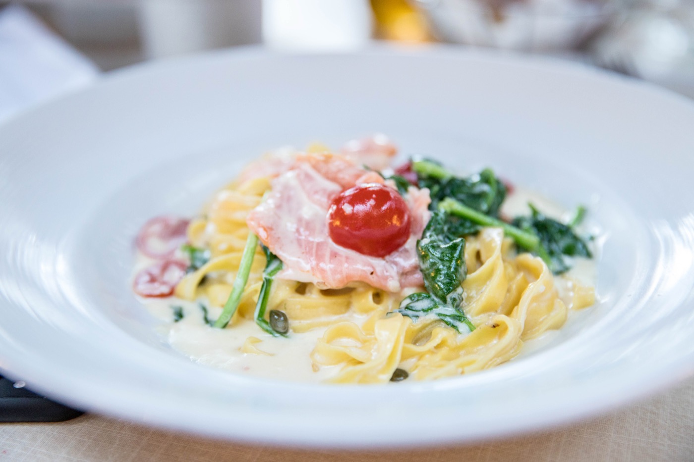 Signature cheese-wheel-tossed risotto prepared tableside at Arancino di Mare.