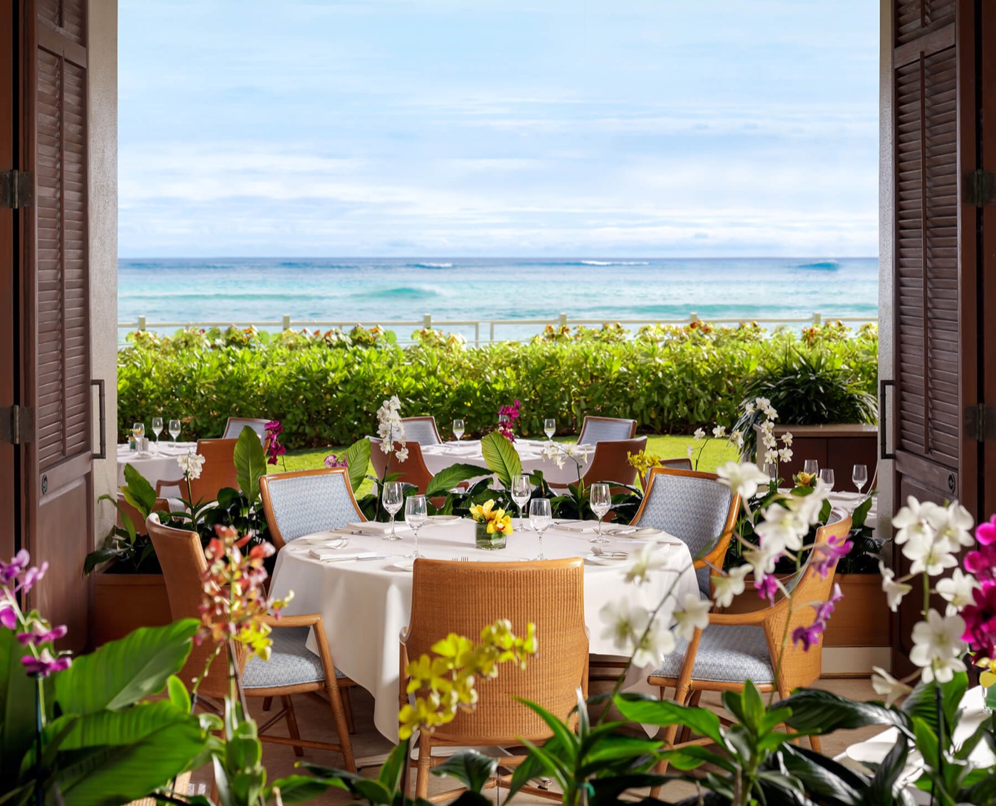 Open-air beachfront dining at Orchids restaurant inside the Halekulani Hotel.
