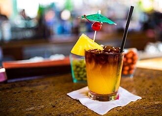 A tropical tiki-style cocktail in the genre of Hideout Waikiki's craft pours.
